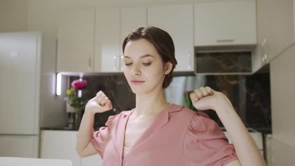 A Business Woman is Stretching After Hard Day alt