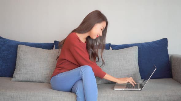 Young asian woman use laptop alt
