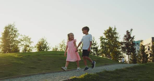 A Boy and a Girl are Walking in the Park alt