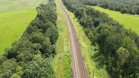 Railroad through green grassed countryside, Aerial