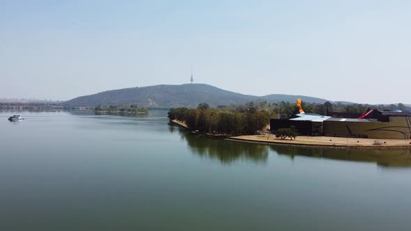 Flying over a beautiful Canberra lake towards the National Museum of Australia and Telstra Tower. alt