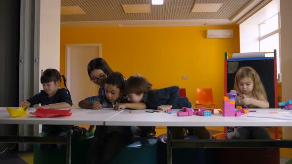 Diverse Kindergarten Pupils Learning at Classroom alt