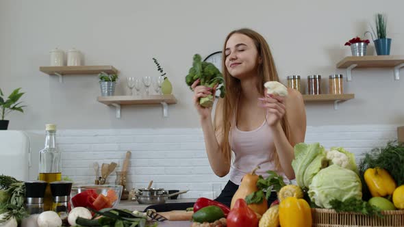 Girl Recommending Eating Raw Vegetable Food. Showing Broccoli and Cauliflower. Weight Loss, Diet alt