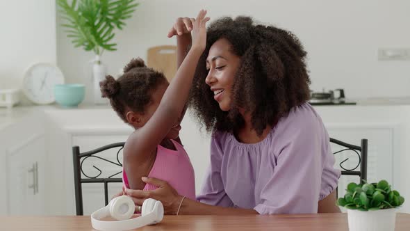 Happy Multiethnic Woman Loving and Caring Mother Gently Hugging and Stroking Her Adorable Beloved alt