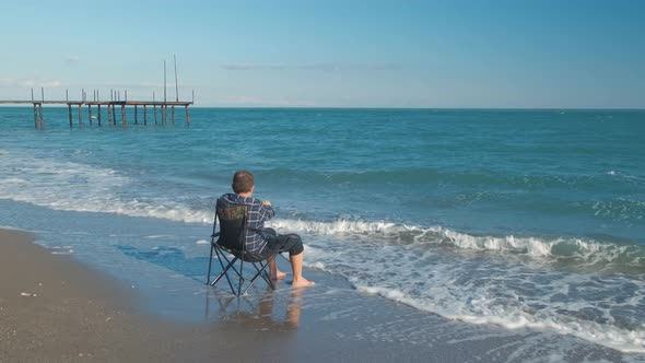 Man Shoots Video on the Beach