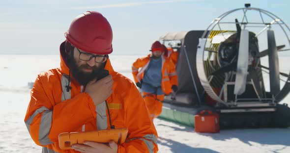 Rescuers on an Aircushion Boat Patrolling Lake in Winter alt