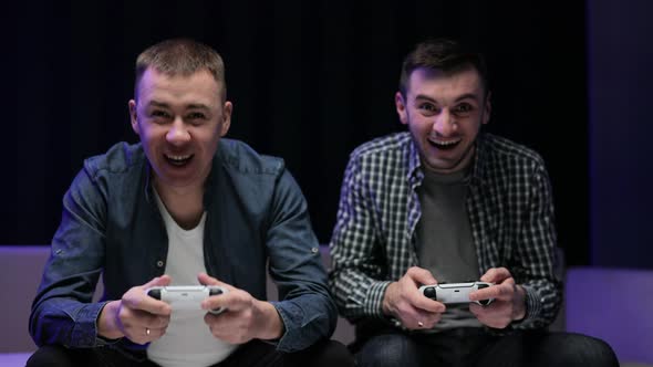 Funny Young Adult Couple Men Gamers Holding Controllers Playing Video Game