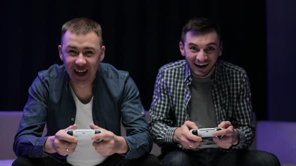 Funny Young Adult Couple Men Gamers Holding Controllers Playing Video Game alt