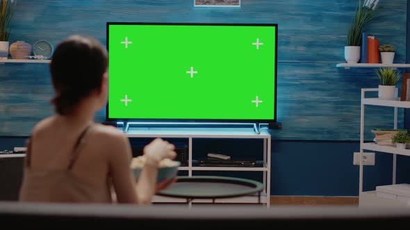 Woman Looking at Tv Designed with Green Screen alt
