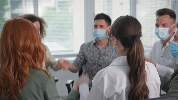 Circle of Trust People Wearing Medical Masks Take Precautions to Hold Hands and Raise Their Hands Up alt