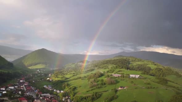 Aerial View of Double Rainbow above Green Country Landscape in Summer Rainy Evening alt