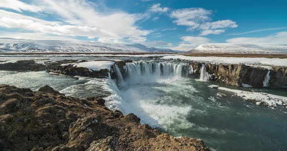  Timelapse View of Godafoss Waterfall, Snowy Shore and River. Iceland in Early Spring