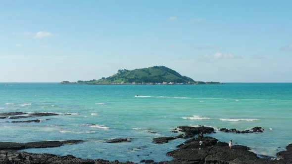 A view of the clear blue sea and the island. Jeju Island. alt