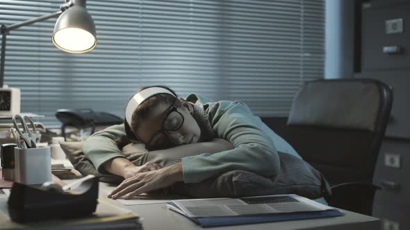 Overworked woman sleeping at her desk