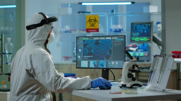 Man Scientist Working at Vaccine Development Typing on Pc in Coverall alt