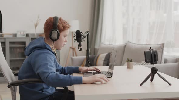 School-aged Blogger Using Computer and Posing alt