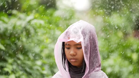 Happy girl wears raincoat and sad alt