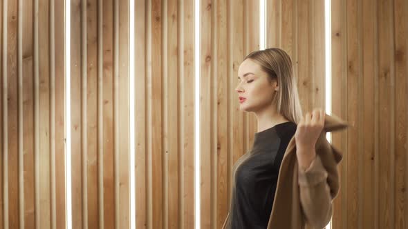 Young Multi-ethnic White Woman Puts on Her Coat and Goes Away alt