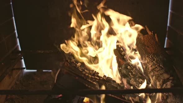 A Brightly Blazing Bonfire Burns the Blackened Firewood and the Walls of the Barbecue alt