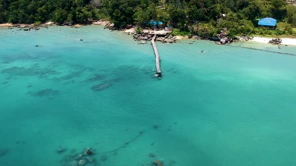Aerial of beautiful turquoise blue sea with old wooden pier Koh Rong Sanloem, Cambodia alt