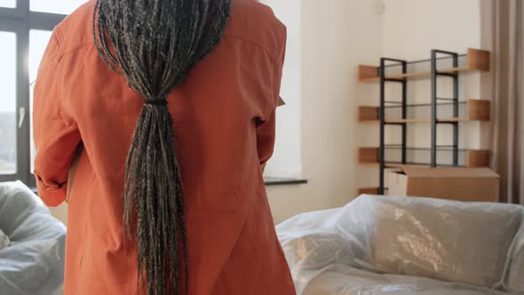 Happy Woman with Box Moving to New Home alt