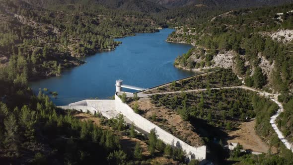 Modern Dam Reservoir on Blue Lake Waters Generate Alternative Energy in Highland Wild Area
