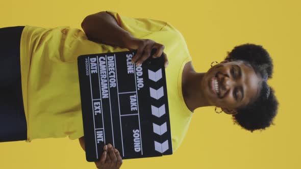 Cheerful Woman Clapping Clapperboard alt
