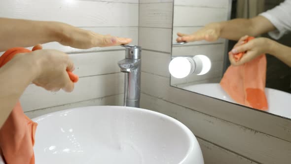 Woman is Cleaning the Tap in the Bathroom Closeup Hands