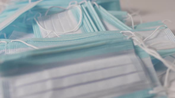 Protective masks dropping on white table alt