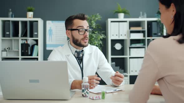 Medical Specialist Talking To Girl Patient Prescribing Medication in Hospital alt
