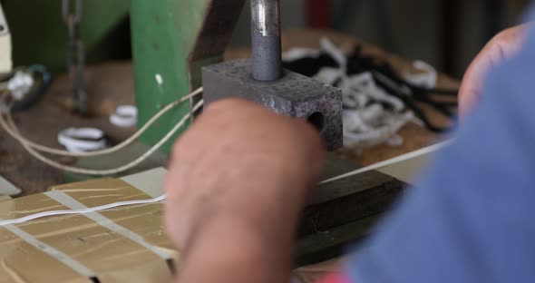 A Sew Factory Worker Cutting Elastic Strips Of Garter With A Machine Cutter - Covid-19 Pandemic - Me alt