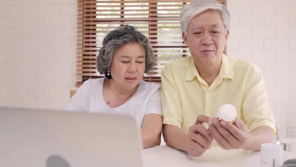 Asian elderly couple using laptop conference with doctor about medicine information. alt