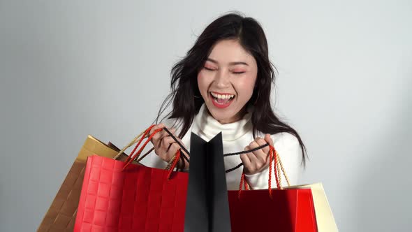 surprised woman holding opened shopping bag