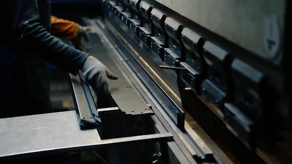 Production of metal corners - the press bends a metal profile.