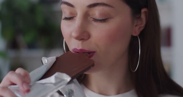Extra Close Up of Sensual Girls Face Enjoying Sweet Chocolate Bar with Closed Eyes Slow Motion