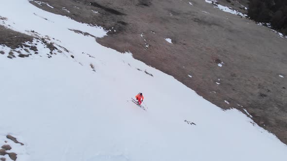 Aerial View of an Extreme Skier Rides on the Grass on a Slope Where There Is No Snow alt