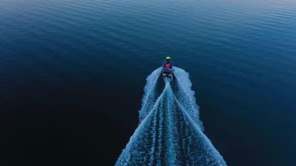 Aerial view of a fishing boat floating in sea alt