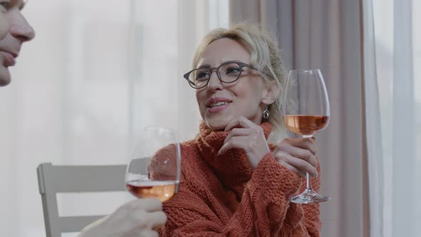 Happy family  couple drink wine and laugh in kitchen. alt