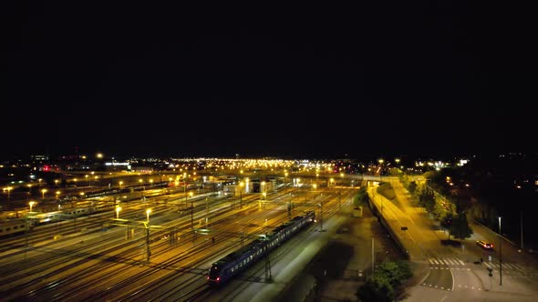 Aircraft following train leaving Malmö at night alt