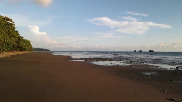 Drone, Low Fly Medium, Sandy Beach, Peaceful waves, green trees, calm cloudy sky alt