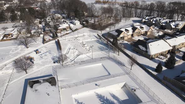 Aerial of closed outdoor Ice Rink due to covid lockdown on a sunny winter day alt