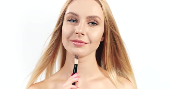 Blonde Woman Applying Makeup Brush Isolated