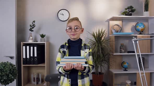 Satisfied Little Schoolboy which Holding on Hands His Books and Looking at Camera at Home alt