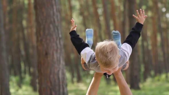 Happy family fun in the park in summer. Young parent father playing with his son alt