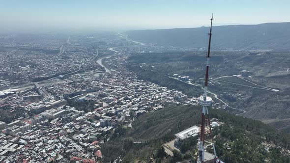 Aerial view of TV Tower in Mtatsminda park. Against the background of the city. Tbilisi, Georgia alt