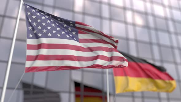 Flags of the United States and Germany in Front of a Skyscraper alt