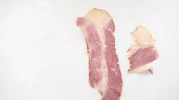 Raw Fed Bacon Strips on White Background  Top View alt