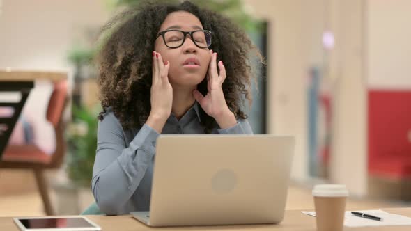 Young African Woman with Laptop Having Headache alt