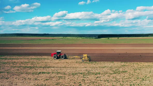 Side View of a Seeding Combine in the Open Field alt