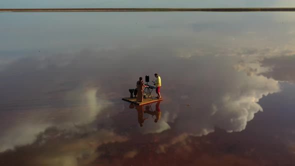 Aerial View on a Band Floating on a Raft in the Sea, Performing, Reflection,  alt